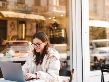 Smiling young woman using laptop