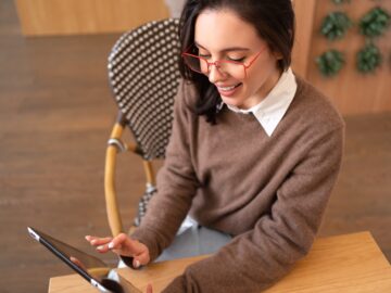 Woman in glasses use tablet computer